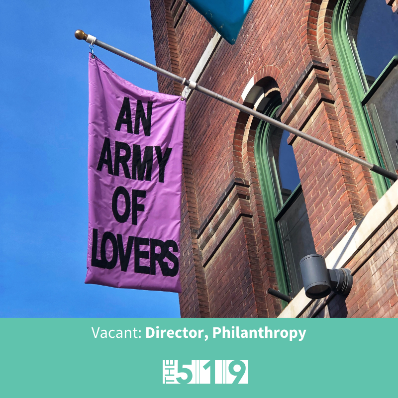 Photo of flag with text An Army of Lovers on the front facade of The 519 building