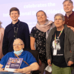 An intergeneration group of people posing for a photo