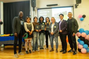 Jayan posing with other particpants and staff at the Building Power Graduation event